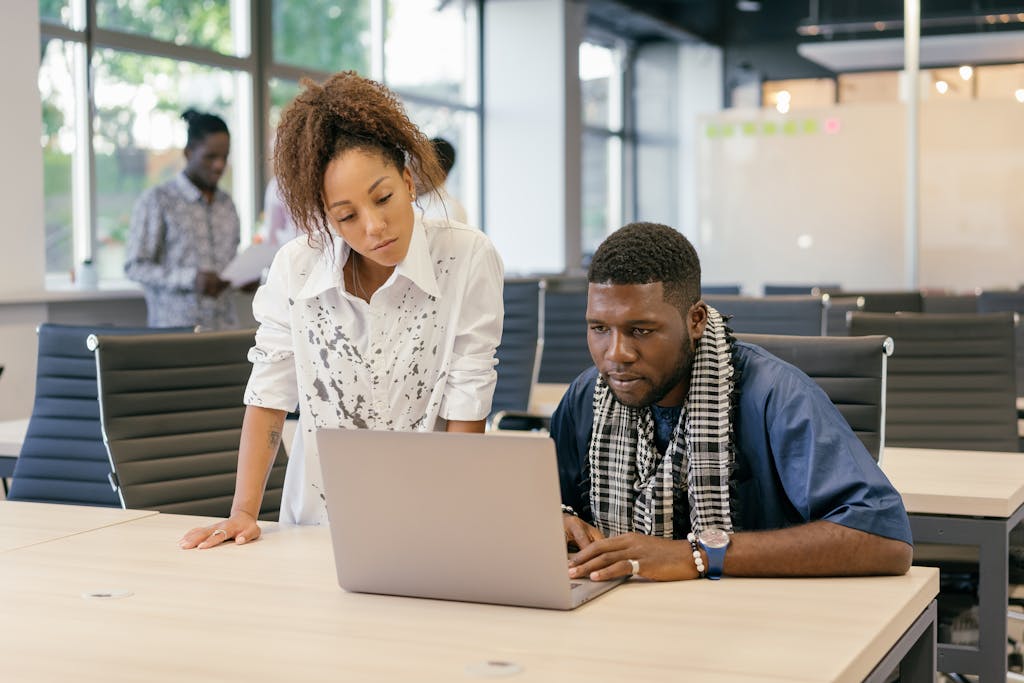 Man and Woman Looking at Laptop Screen